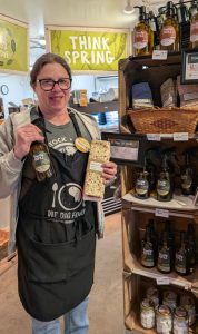 Amelia with the Rise Up Refill display at Woodstock Famers' Market Waterbury market.
