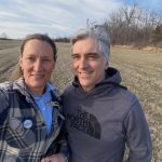 Blue Ledge Farm cheese available at Woodstock Farmers' Market. Image shows a woman and a man standing in an open field in early spring.