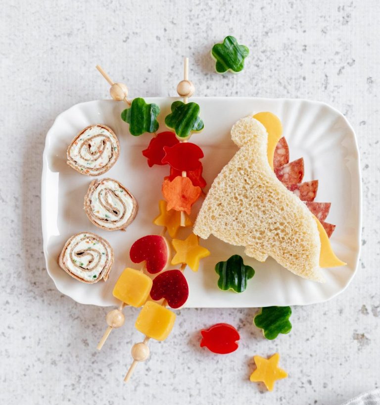 Back to School lunch at Woodstock Farmers' Market. Image shows pinwheels, fruits and veggies cut into shapes, and a dinosaur-shaped sandwich.